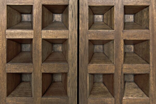 Dark walnut sideboard with four deeply coffered doors. close up