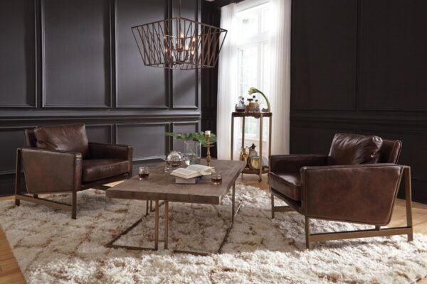 brown leather accent chair with bronze legs in living room setting