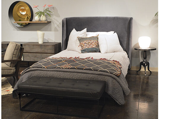 dark grey velvet bed in bedroom setting