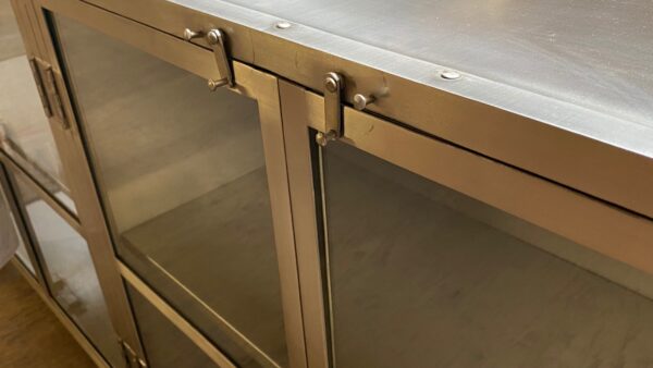 Nickel finish cabinet with glass doors detail of latches