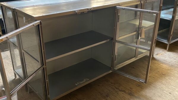 Silver media console cabinet with glass doors open