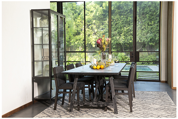 tall black metal and glass cabinet in dining room setting
