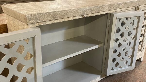 whitewash sideboard media console with carved out doors interior view
