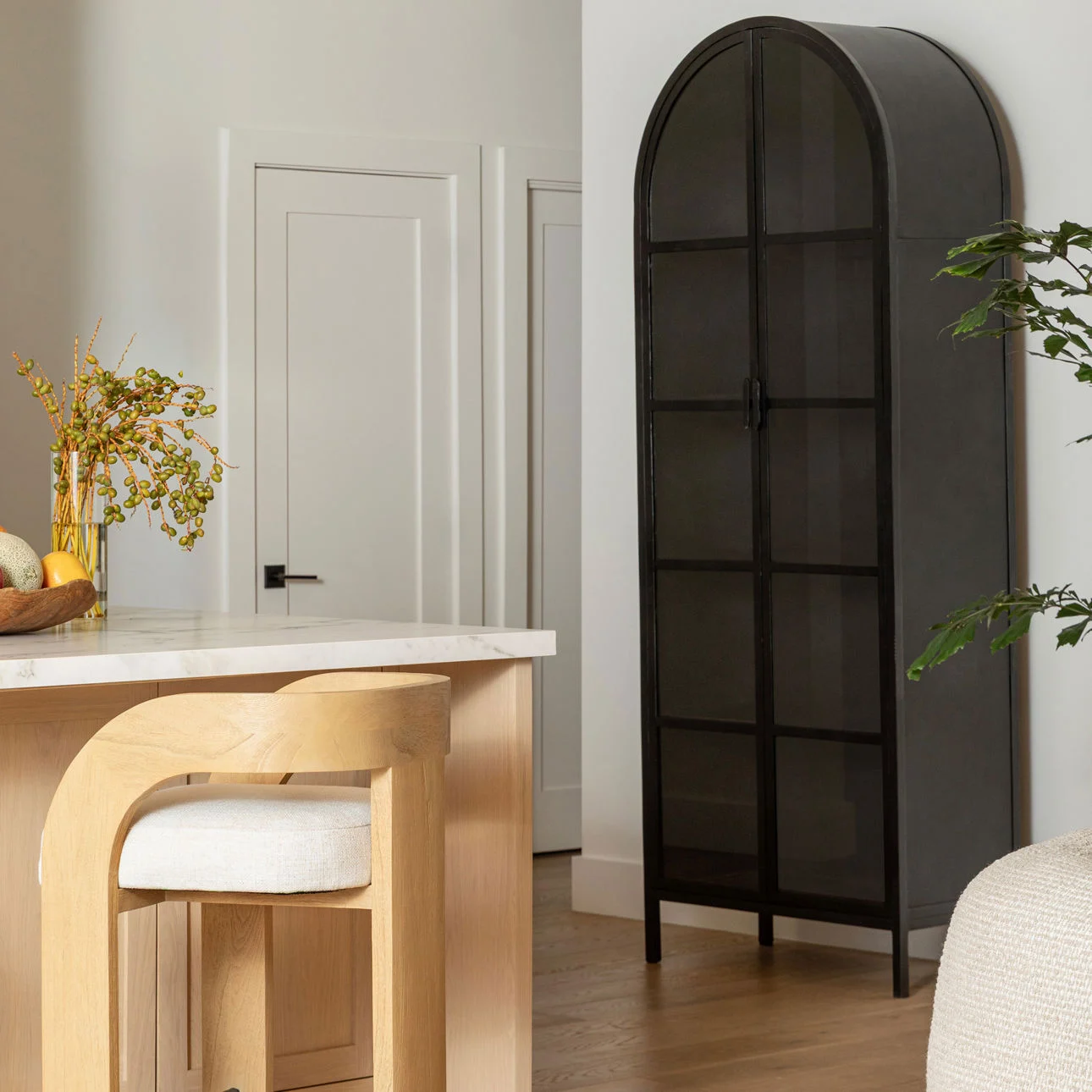 Kiera 2-door black metal cabinet with glass doors and arched top, modern storage display cabinet for living room, dining room, or office. Staged view