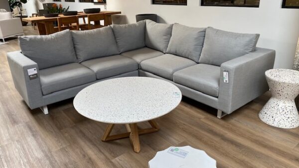 Aluminum and grey cushions outdoor sectional shown with round coffee table