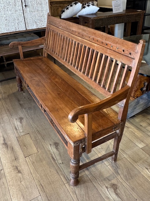 Antique Indonesian teak bench made from reclaimed solid wood with natural grain, warm patina, and handcrafted detailing. Profile view