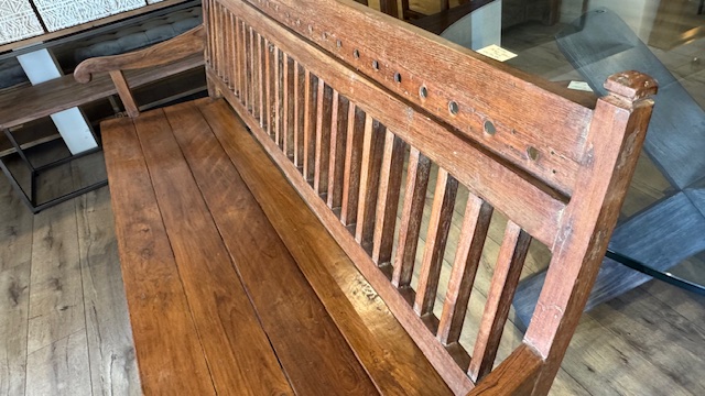 Antique Indonesian teak bench made from reclaimed solid wood with natural grain, warm patina, and handcrafted detailing. Detail