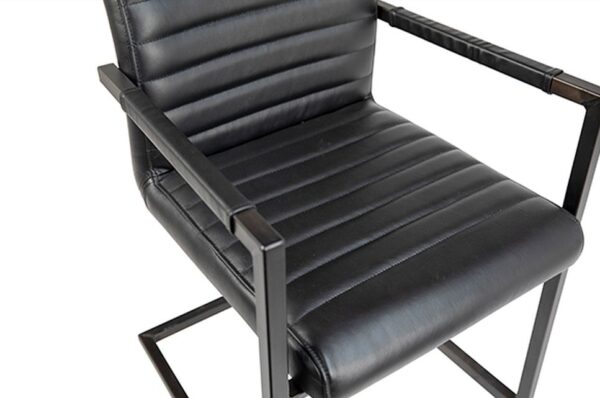 black leather dining chair with arms and metal legs seat detail
