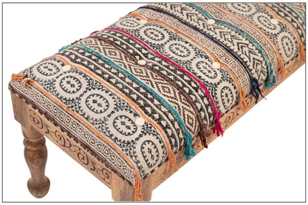 Wood bench with multicolor Indian fabric close up