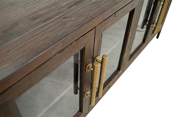 long dark wood console with glass doors and brass handles detail