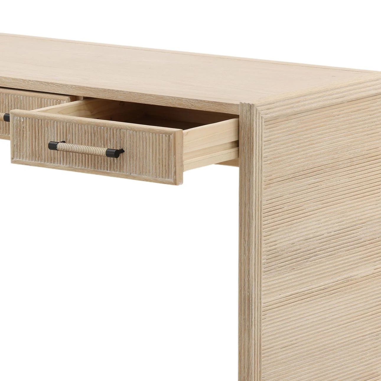 The Isla Desk is crafted from solid oak wood with a beautiful light natural finish. Featuring reeded details and three drawers, it's perfect for a home office or vanity, open drawer