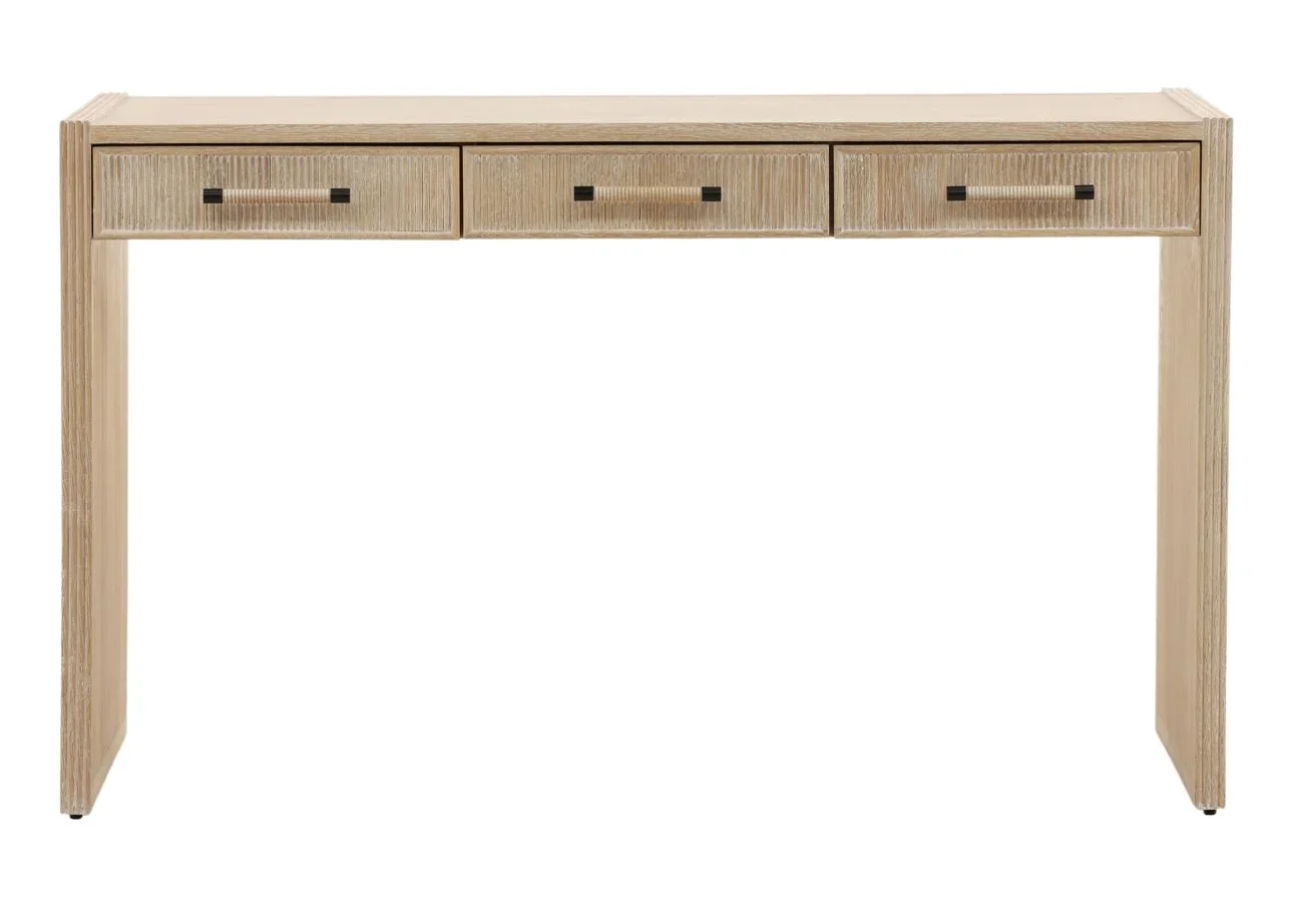 The Isla Desk is crafted from solid oak wood with a beautiful light natural finish. Featuring reeded details and three drawers, it's perfect for a home office or vanity, front view
