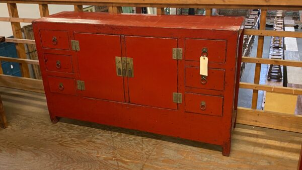Red Chinese cabinet showing 6 drawers and 2 center doors