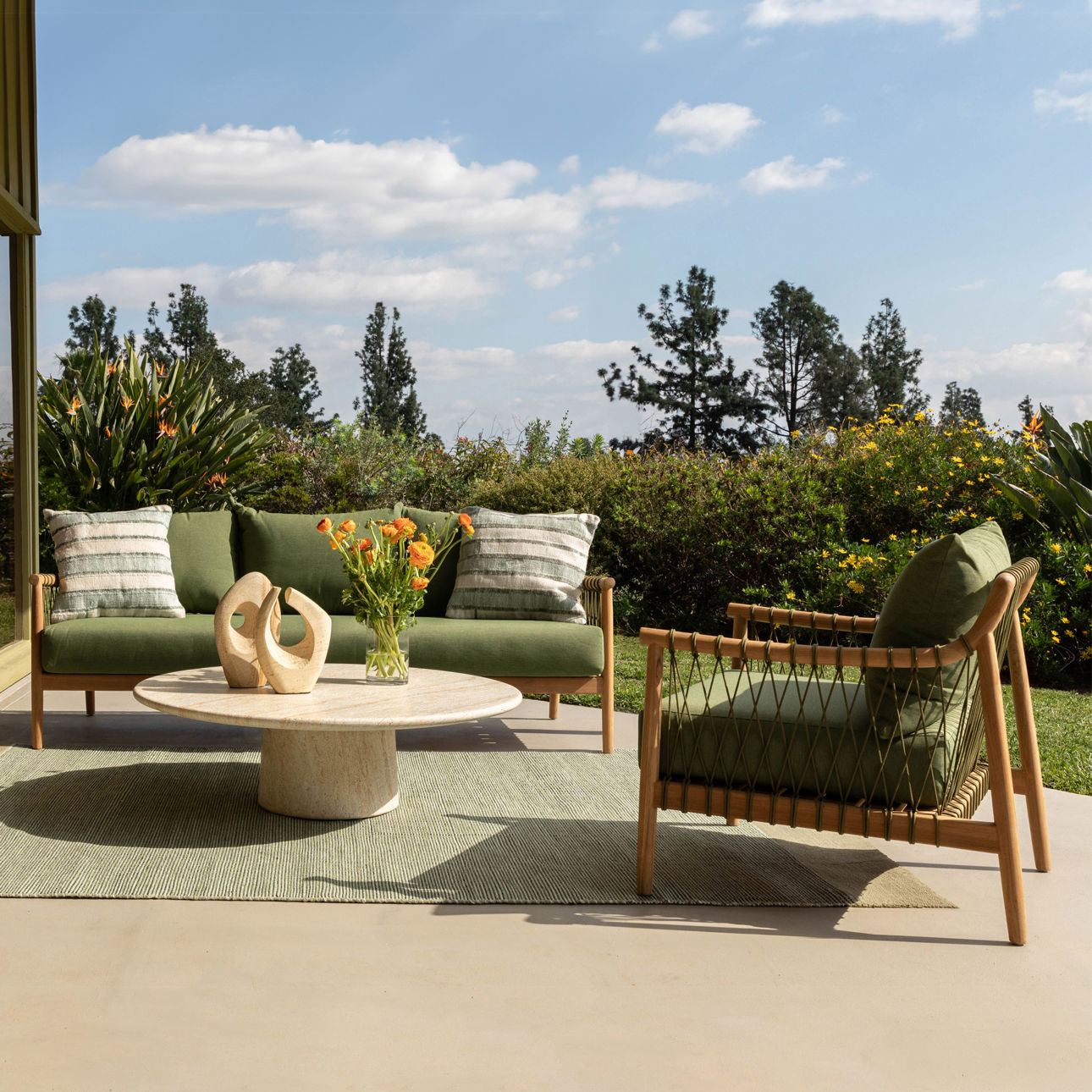 Solid teak club chair in natural wood finish with weather-resistant greencushions. Perfect for outdoor use, outdoor view