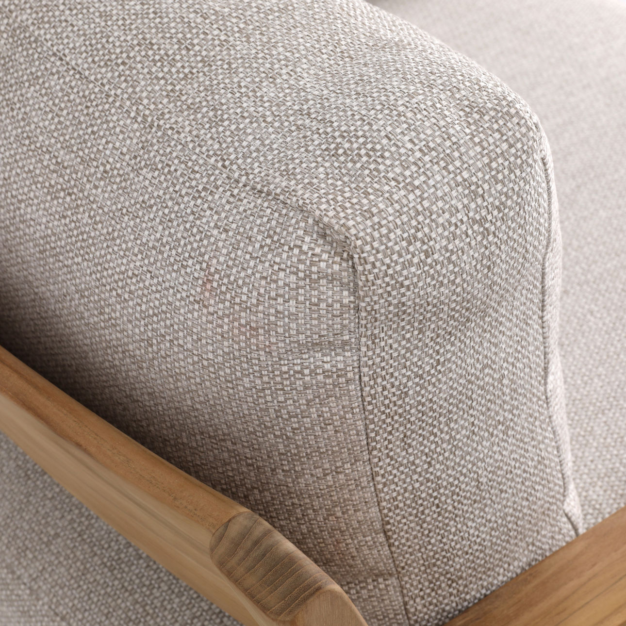 Solid teak club chair in natural wood finish with weather-resistant taupe cushions. Perfect for outdoor use, upper corner view