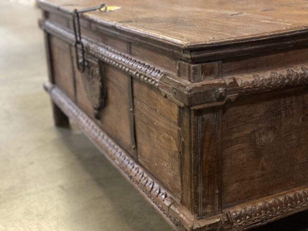 Brown vintage trunk with carved body, side view