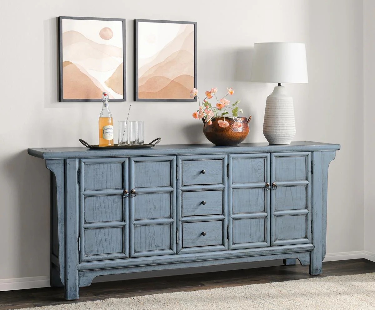 Antique blue, Asian style sideboard with doors and drawers, shown in a home