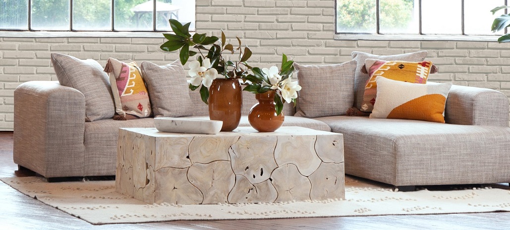 Natural color sectional with rustic teak coffee table.