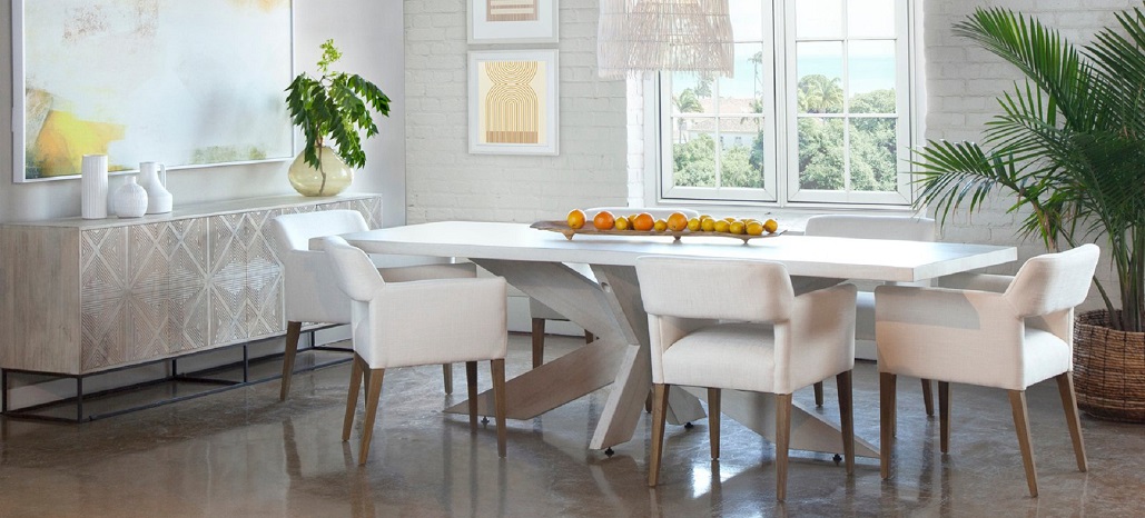White dining table with crossbeam base, white chairs and white sideboard.