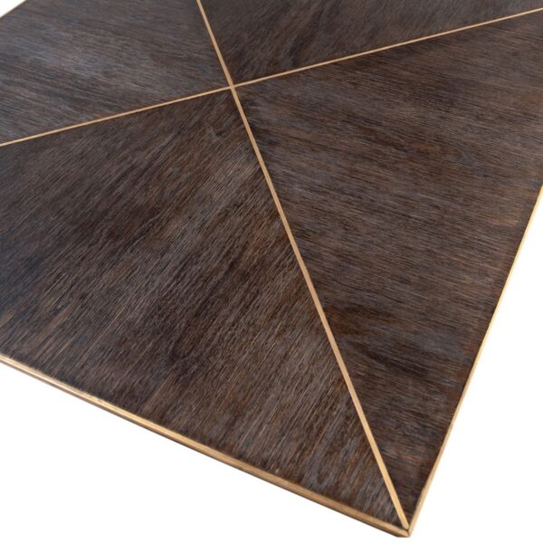 Dark oak dining table with brass details. top closeup