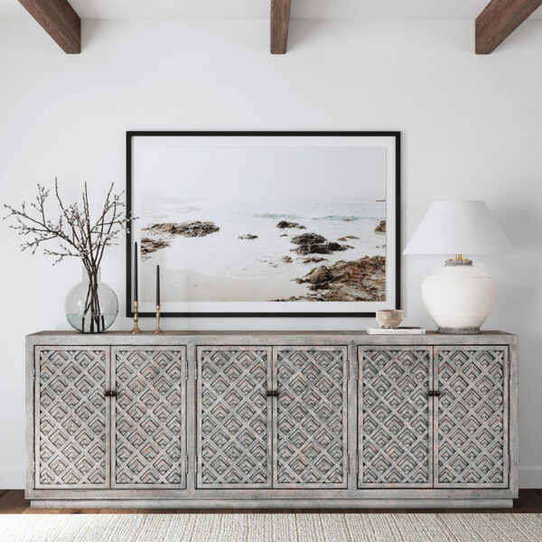 Large carved sideboard media console with antique blue finish, shown in home setting
