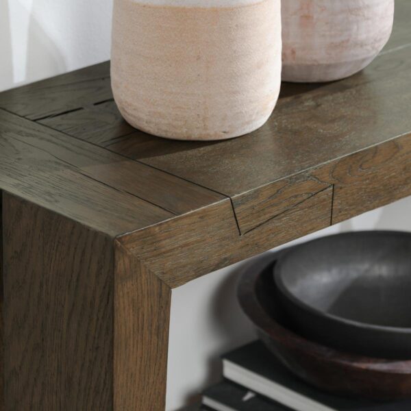 Brown oak wood console table with bottom shelf, corner detail