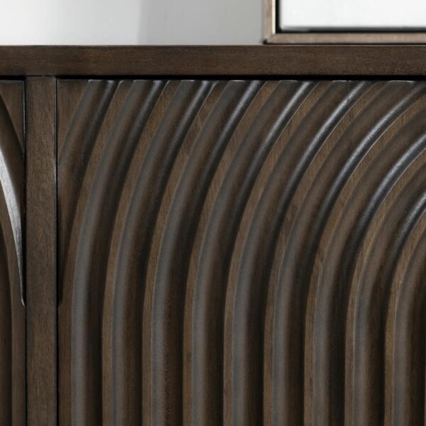 Dark brown media cabinet with curved, textured front, door detail