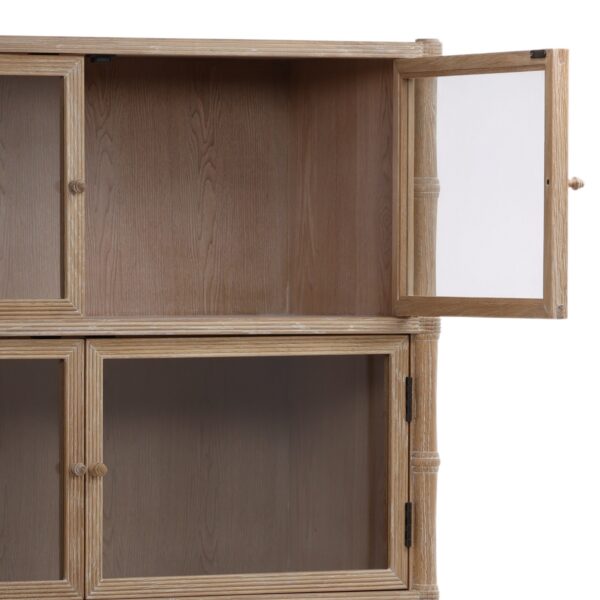 Tall cabinet made of light oak wood with glass doors, detail