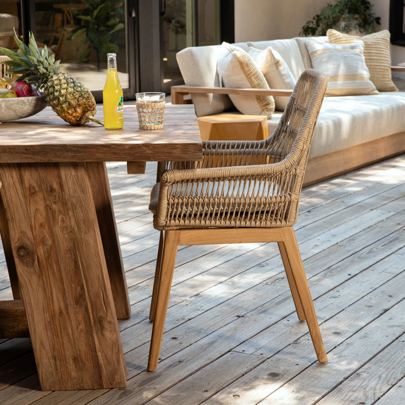 Teak and rope outdoor dining chair, patio setting profile view