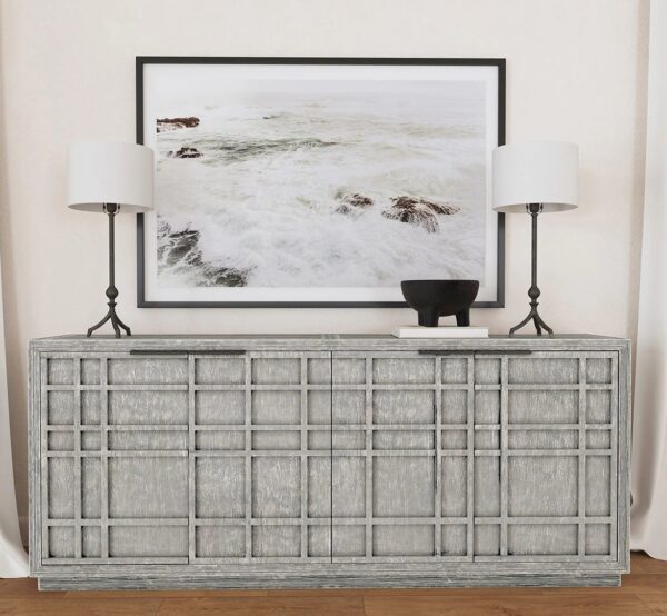 Four door media console with rustic grey wash finish, shown with lamps and painting on top