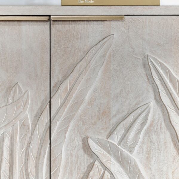 Whitewash media console with hand carved foliage on doors, close up