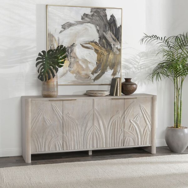 Whitewash media console with hand carved foliage on doors, shown in home setting