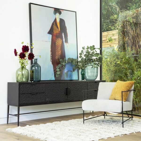 Slim and long black sideboard with drawers seen in home setting