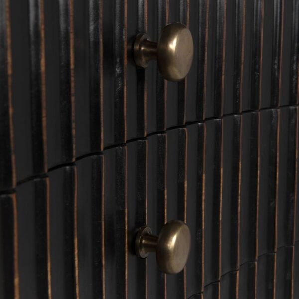 Black dresser with curved front and gold undertone, close up