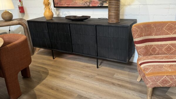 Four door black sideboard on a metal base and four designer doors, shown in room