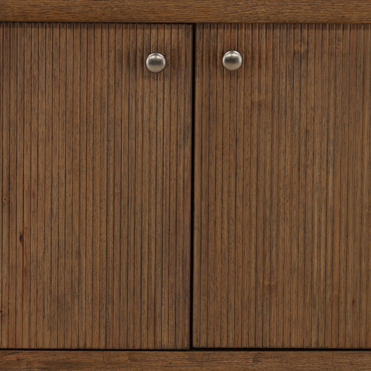 Dark brown rubber wood sideboard with reeded four-door front, round metal knobs, and an open lower shelf for storage or display, detail view