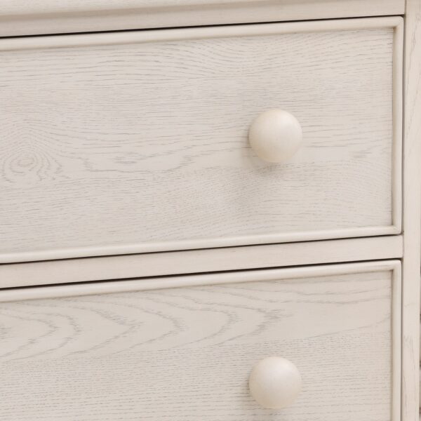 Small whitewash dresser with 3 drawers and spindle accents, close up