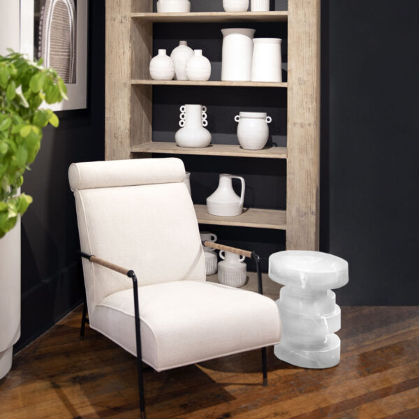 Modern rustic bookshelf with 4 shelves in a light warm wash finish, shown in vignette with chair