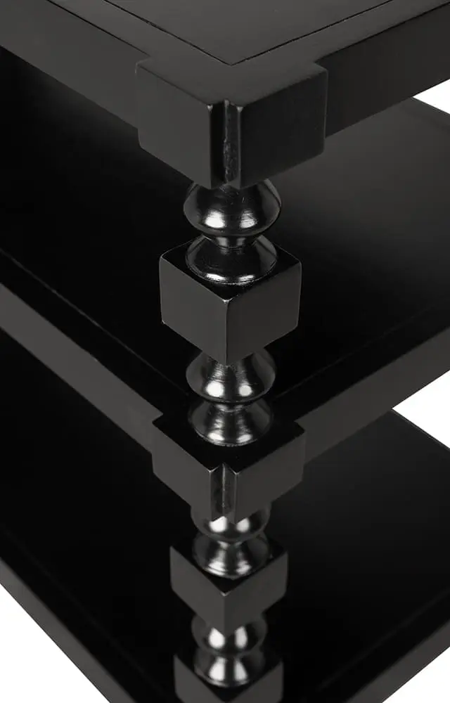 Black three-tier console table with spindle legs and open shelving design, detail
