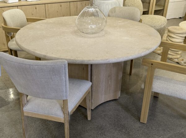 59” Diameter cream marble top dining table with light colored oak unique base, from showroom