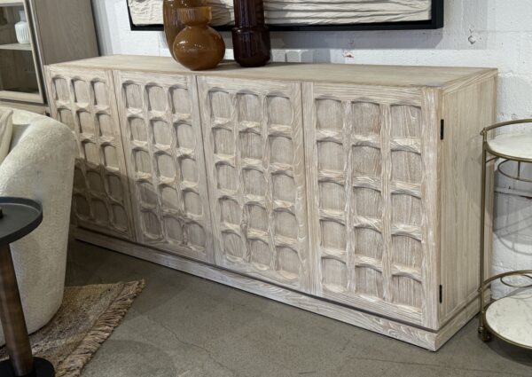 4 Door whitewash sideboard with design doors and plenty interior storage, staged in a room